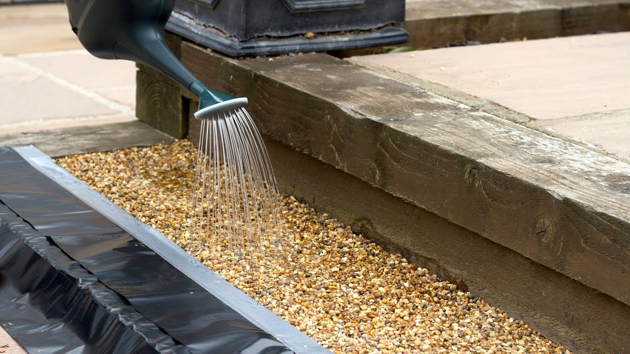 Pour-on resin binder being applied before stone is scattered in a resin bonded system